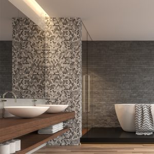 Modern bathroom interior with stone wall tiles around bathtub