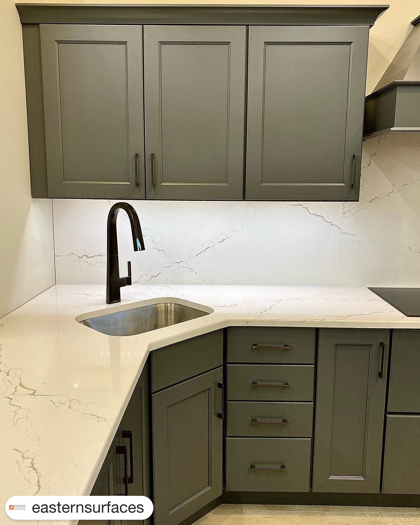 Cambria Surfaces Inverness Frost flowing through a full height backsplash in this Eastern Surfaces fabricated and installed display top!