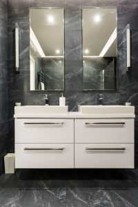 Dark granite bathroom with cabinet