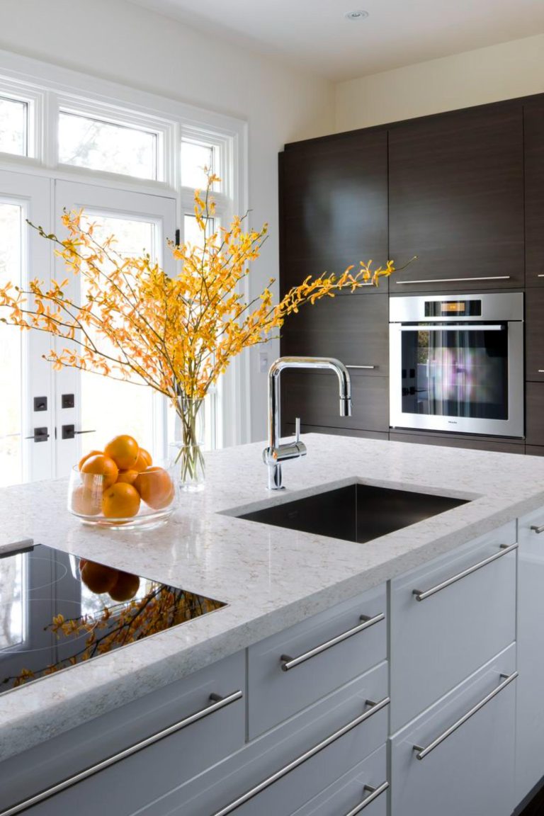 Viatera quartz kitchen countertops with modern sink and vibrant decor