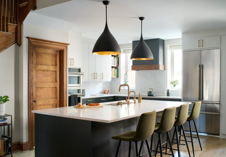 Contemporary kitchen island with white countertops and gold fixtures
